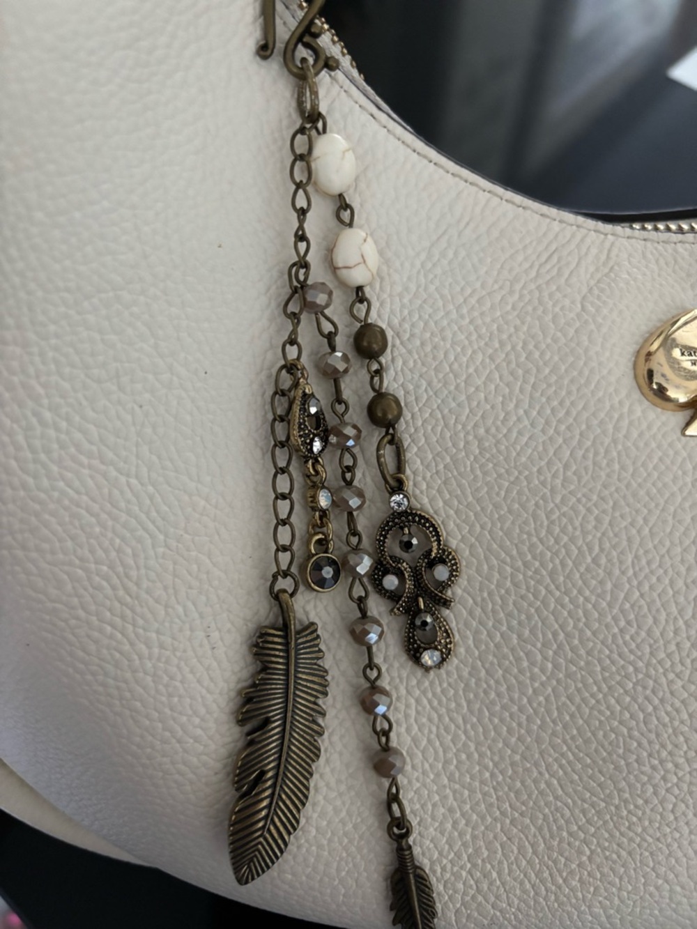 Vintage antique brass handmade beaded with feather design bag charm.